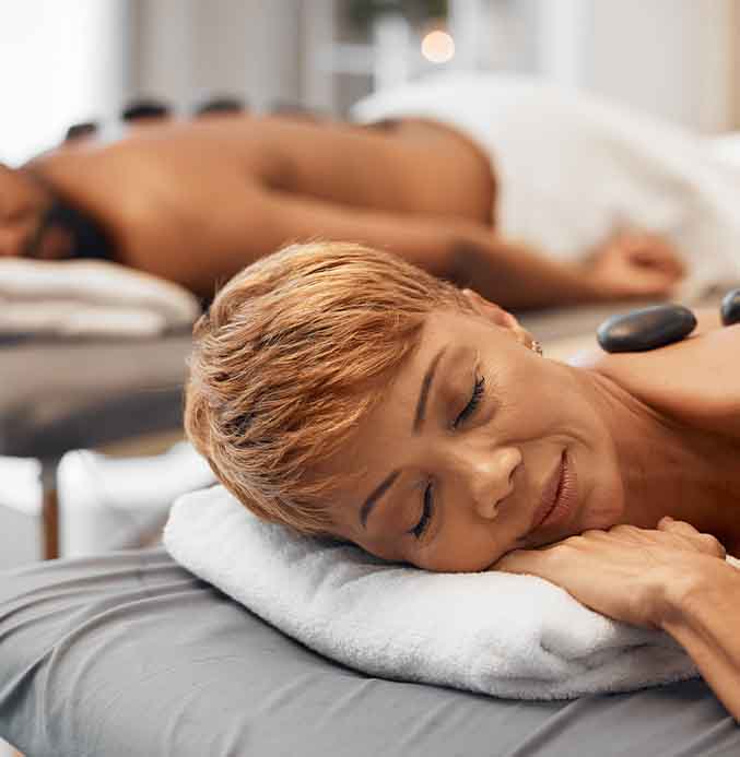 Black couple enjoying a hot stone couples massage at Majestic Medical Touch Spa in Atlanta